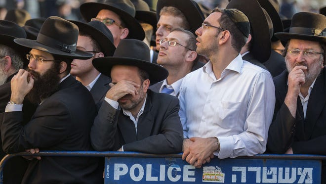 Ultra-Orthodox Jews mourn victims of Tuesday’s savage rampage in the Har Nof neighborhood in Jerusalem.