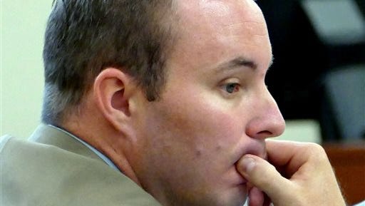 FILE - In this Aug. 17, 2015, file photo, Charlotte-Mecklenburg police Officer Randall "Wes" Kerrick sits at the defense table during his manslaughter trial in Charlotte, N.C.  State attorneys on Friday, Aug. 28, 2015, decided against retrying Kerrick, who shot and killed an unarmed black man after his trial ended in a deadlock last week. (Davie Hinshaw/The Charlotte Observer via AP, Pool, File)