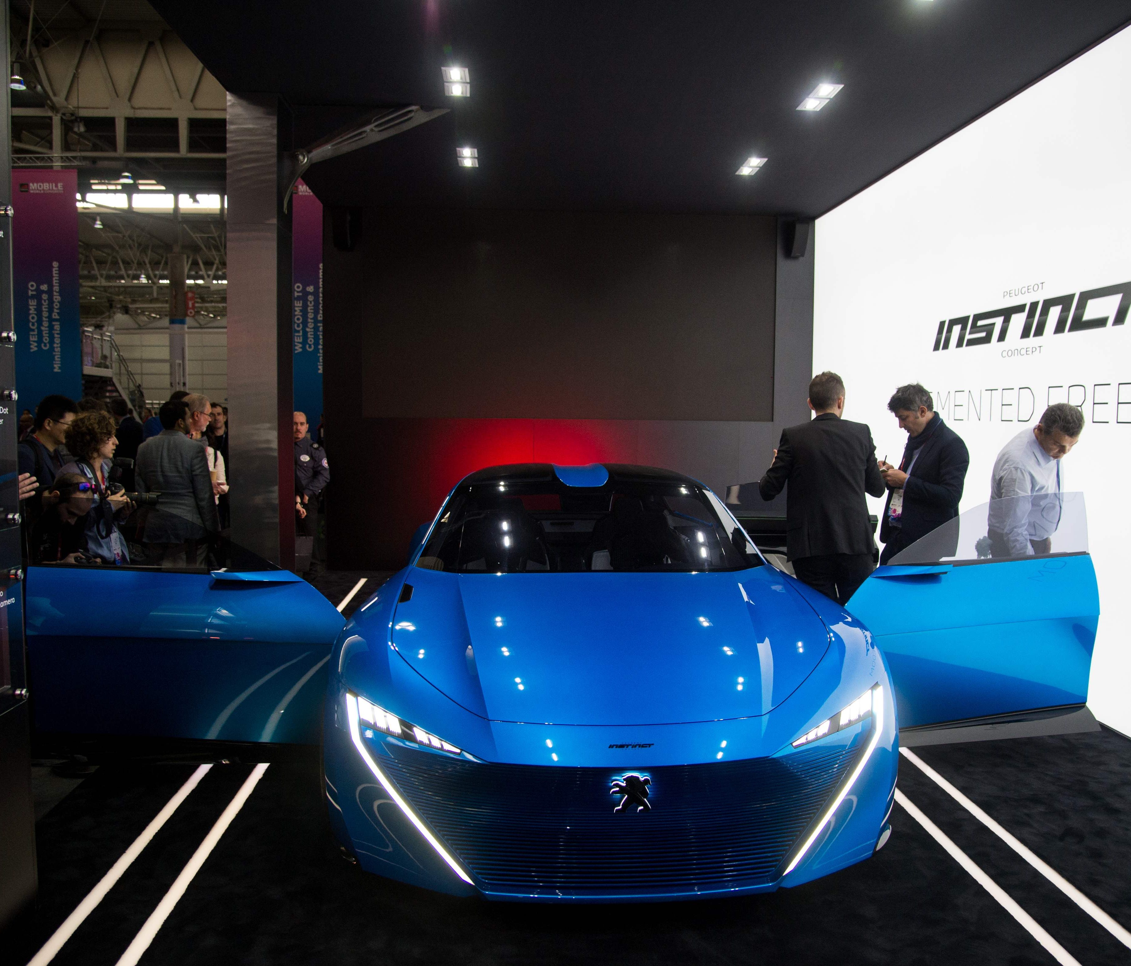 The company buying GM's European operatinos, PSA Groupe, is an agile competitor. Here, visitors look at the Peugeot car 