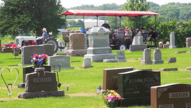 Trolley-like people-movers carried crowds through the monuments at Laurens cemetery this summer to visit historic graves and hear volunteer actors speak for community leaders from the past.