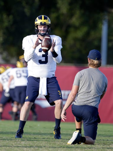 Michigan quarterback Wilton Speight takes a snap during