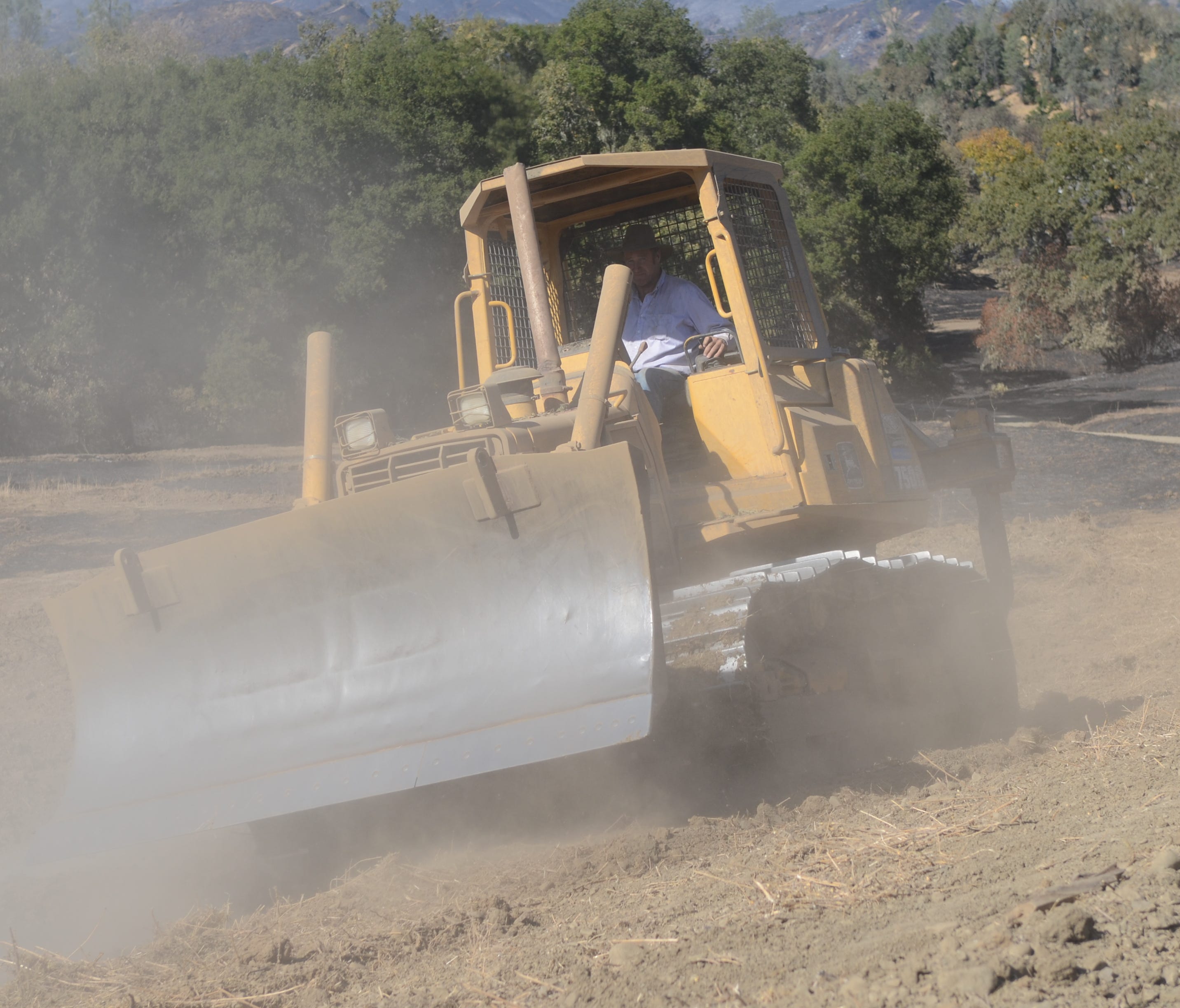 A resident of Capell Valley, Calif., runs a bulldozer in the hills above the valley floor.