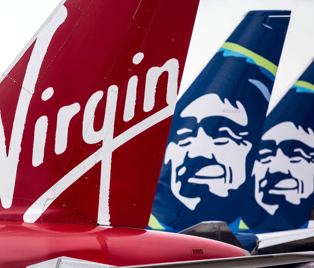 Virgin America and Alaska Airlines tails are seen at Seattle-Tacoma International Airport on March 24, 2017.