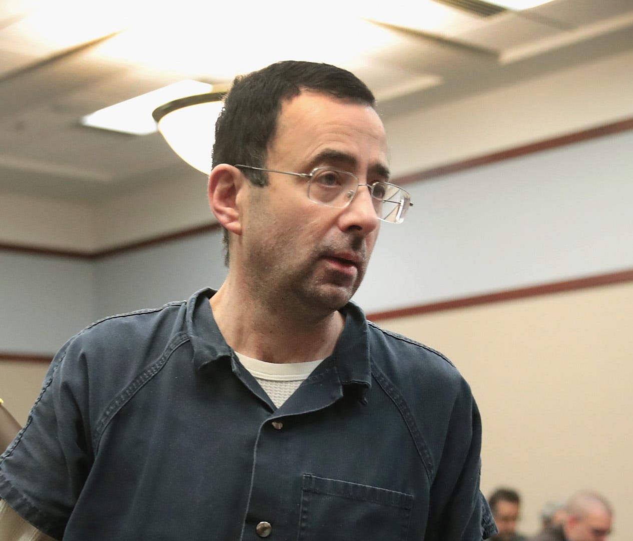 LANSING, MI - JANUARY 17:  Larry Nassar appears in court to listen to victim impact statements during his sentencing hearing after being accused of molesting more than 100 girls while he was a physician for USA Gymnastics and Michigan State Universit