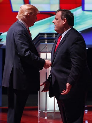 Donald Trump, left, and Chris Christie talk together during a break in the CNN Republican presidential debate at the Venetian Hotel & Casino on Tuesday, Dec. 15, 2015, in Las Vegas.