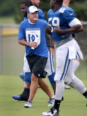 Indianapolis Colts head coach Chuck Pagano stretches out with the team during training camp Tuesday at Anderson University.