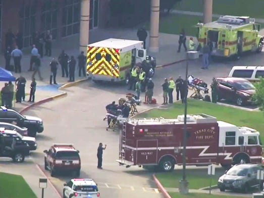 In this image taken from video emergency personnel