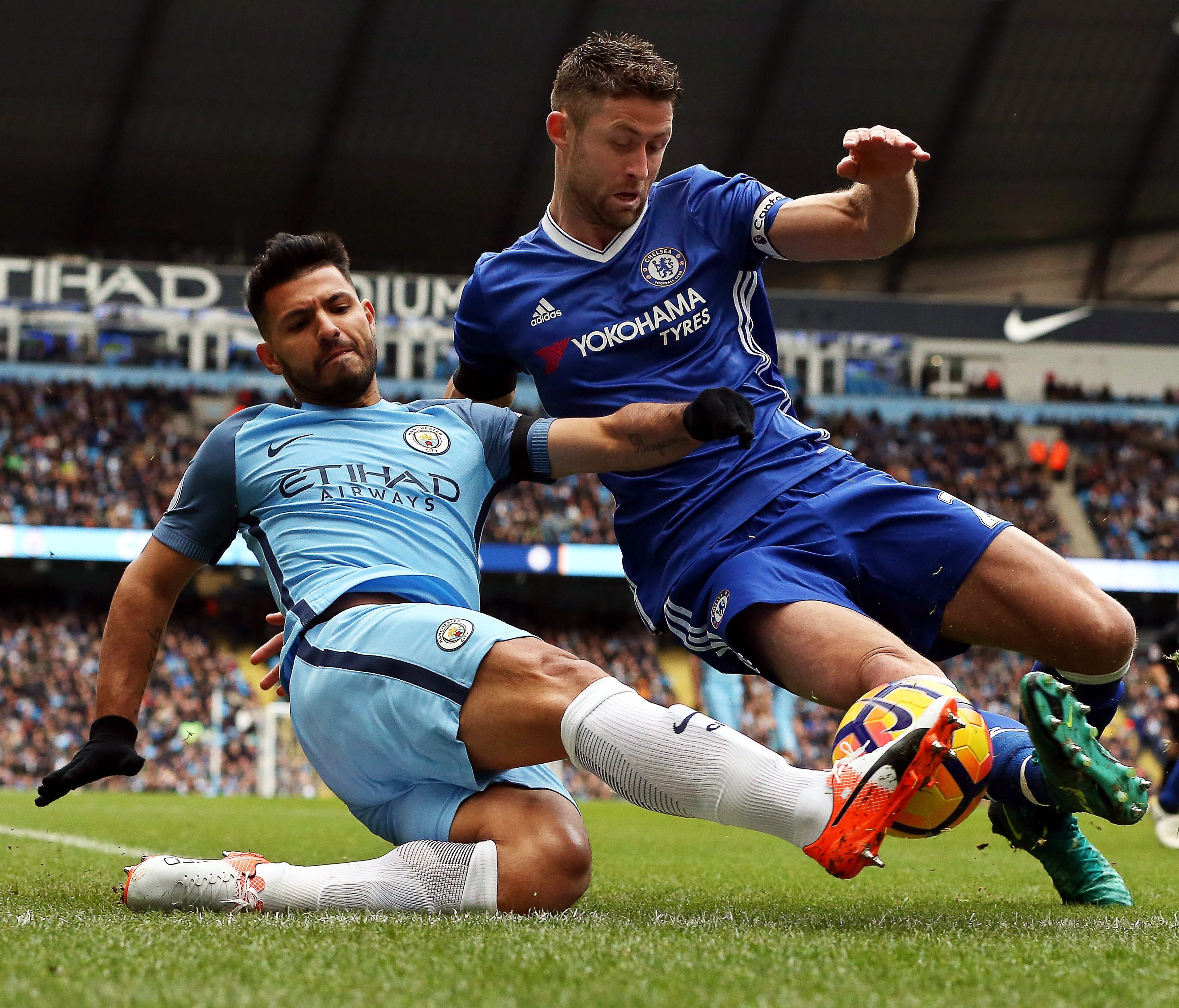 Manchester City forward Sergio Aguero fights for the ball with Chelsea defender Gary Cahill.