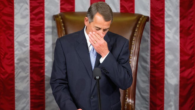 Outgoing House Speaker John Boehner waits for Rep. Paul Ryan to arrive into the House Chamber on Capitol Hill in Washington on Thursday.