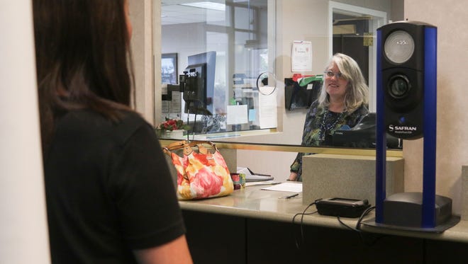 Judy Bradbury renews Helen Gross' driver's license at City Hall on Thursday. Renewal services are now being offered at City Hall effective June 2.