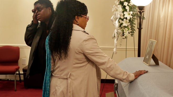 
Lakisha Murdough, left, and Cheryl Warner, the daughter and sister of Jerome Murdough, pause at his casket before his funeral at the Cobbs Funeral Chapel, in the Queens borough of New York, Friday, April 25, 2014. A modest family funeral was held for 56-year-old Jerome Murdough, a homeless former Marine who was found dead more than two months ago in an overheated New York City jail cell.
