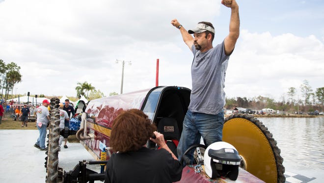 Eddie Chesser stands in The Rapture and celebrates his win during the Swamp Buggy Races on Saturday, March 25, 2017 at Florida Sports Park in East Naples. 