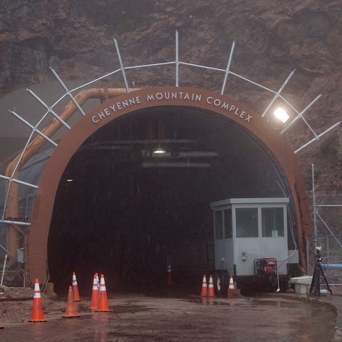 Rain falls in front of the iconic entrance to the 