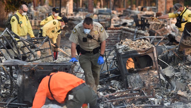 A search and rescue team searches for bodies at a property where a person was reported missing in Santa Rosa, California on October 12, 2017.