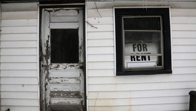 An old "For Rent" sign is seen in the window at the James Smith Farm House, which is a Michigan Registered Historic Site that was built between 1820 and 1850 and is considered the second-oldest house in the city of Detroit.