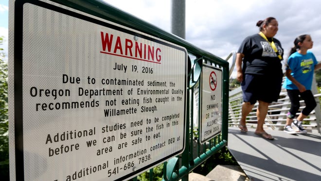 A sign installed by the city warning people of high levels of dioxins in sediment in the Willamette Slough at Riverfront Park in Salem on Tuesday, July 19, 2016.