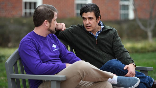 Akan Malici, right, talks to a student at Furman University. Malici will participate in a panel discussion, "The Public Responsibility of Scholars," today (Thursday) at Furman.