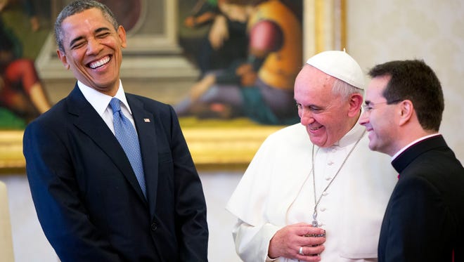 President Obama meets Pope Francis at the Vatican on March 27, 2014. Francis will pay a call on Obama at the White House on Sept. 23. The clergyman at right is a translator.