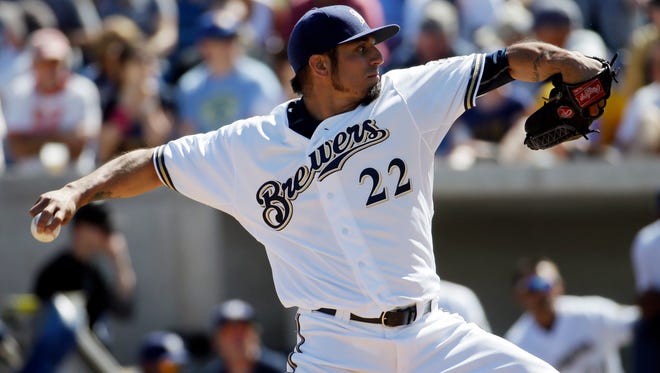 Milwaukee Brewers starter Matt Garza throws during the first inning of a spring training baseball game against the Los Angeles Dodgers.