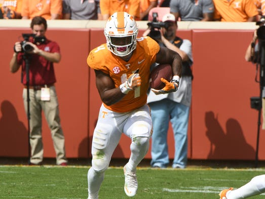 Tennessee running back John Kelly (4) runs with the