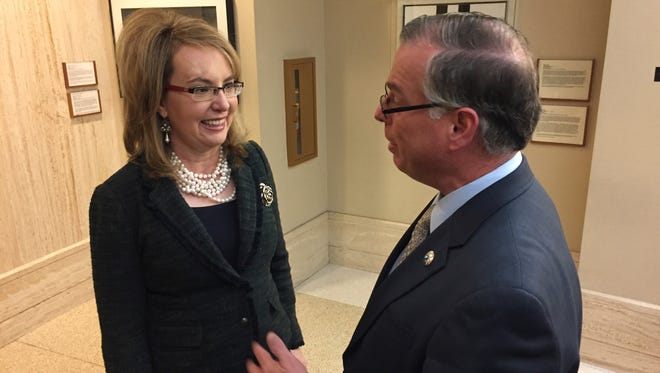 Former U.S. Congresswoman and mass shooting survivor Gabrielle Giffords, left, talks with Democratic New Mexico Sen. Daniel Ivey-Soto in Santa Fe, N.M., on Wednesday, Feb. 22, 2017. Giffords and her national gun-safety advocacy group Americans for Responsible Solutions are trying to build support for bills that would expand background checks on private firearms sales in New Mexico and remove guns from domestic violence situations where a restraining order has bee issued.