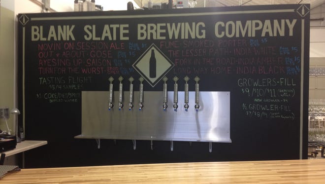 A board lists what's on tap at Blank Slate Brewing Company's new tap room.