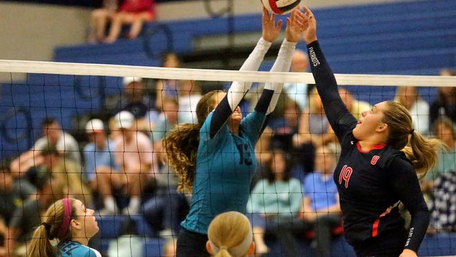 Siegel's Julia Wheeler (13) and Oakland's Briley Hale-Jarrell (19) square off at the net during the match on Tuesday, Sept. 20, 2016, at Siegel.