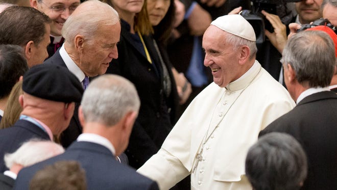 Pope Francis shakes hands with U.S. Vice President Joe Biden as he takes part at a congress on the progress of regenerative medicine and its cultural impact, being held in the Pope Paul VI hall at the Vatican,  Friday, April 29, 2016.