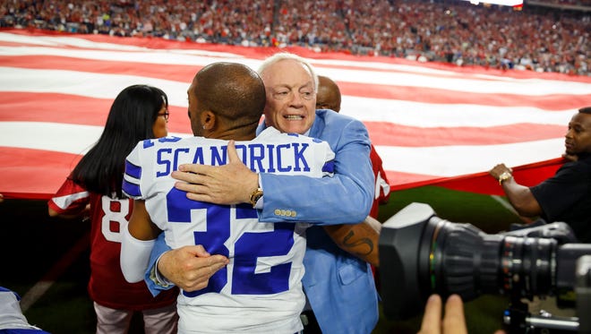 Cowboys owner Jerry Jones hugs CB Orlando Scandrick following the national anthem last month.