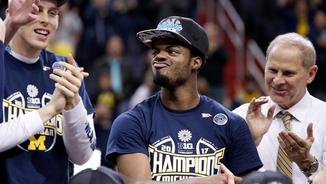 Michigan guard Derrick Walton Jr., center, reacts after being named most outstanding player for the Big Ten tournament.