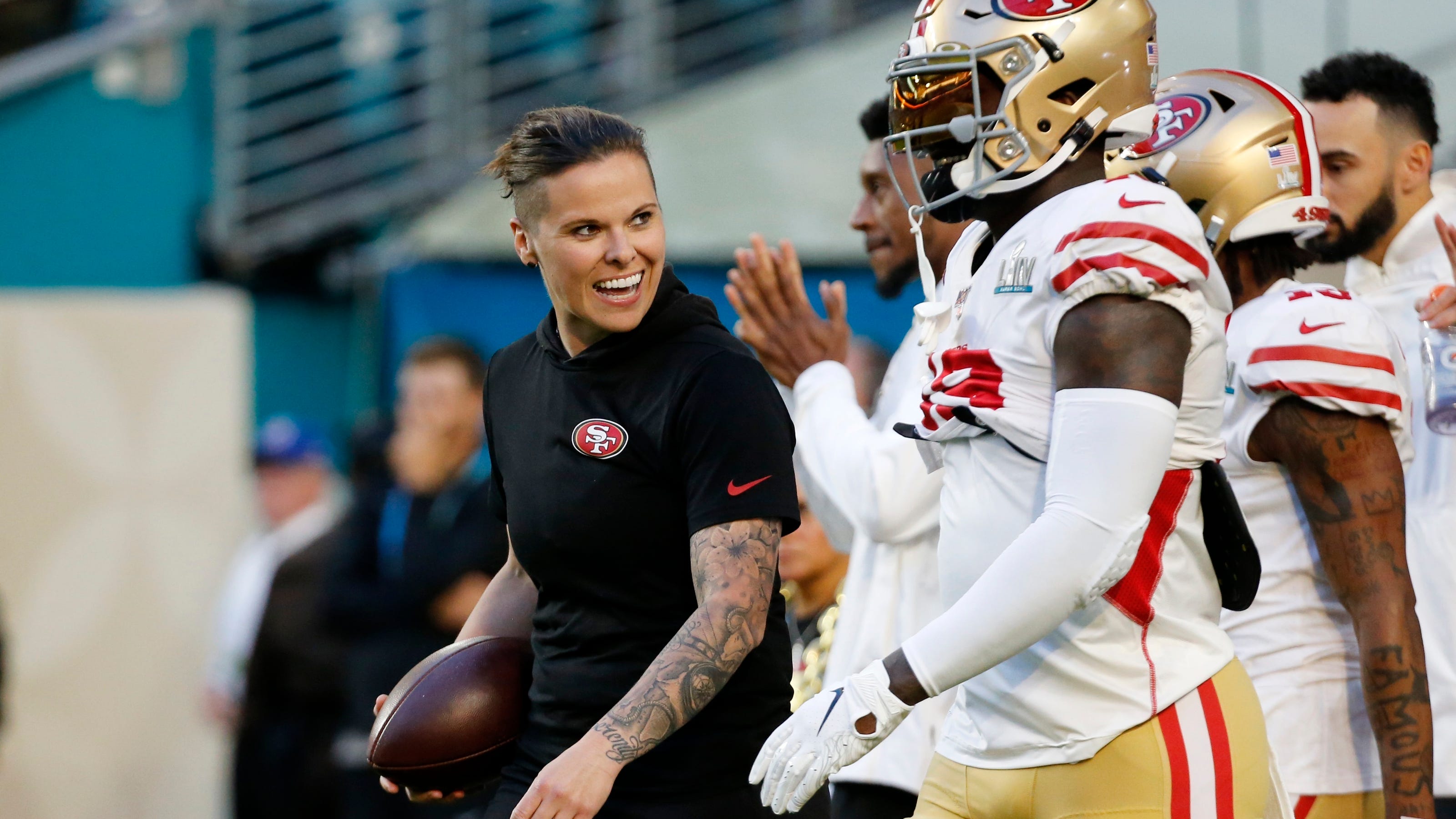 Katie Sowers makes history as 1st woman coach at Super Bowl.
