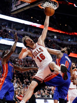 Chicago Bulls forward Pau Gasol dunks against Detroit Pistons guard Kentavious Caldwell-Pope, left, and center Andre Drummond during the second half on Friday, April 3, 2015, in Chicago. The Bulls won 88-82.