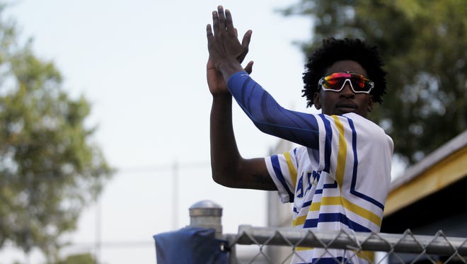 Rickards senior Javon Peterson pumps up his home crowd during a Region 1-5A semifinal Friday against Marianna.