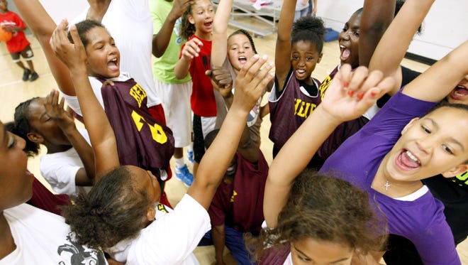 Basketball players cheer at the end of practice at the John R. Grubb YMCA in this 2012 file photo.