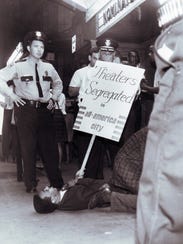 Avon Rollins protests on the sidewalk at the Tennessee