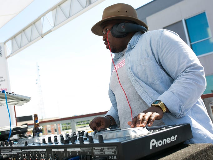 DJ Modise performs for the crowd during the Sunsets