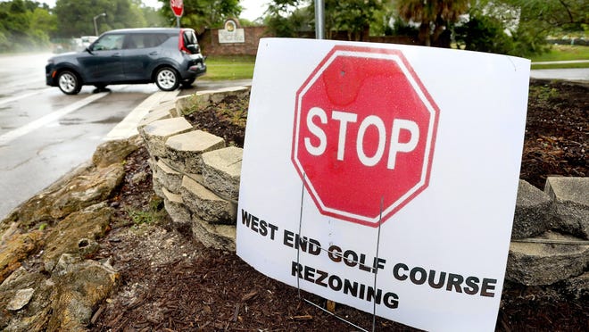 A sign opposing the rezoning of what was the West End Golf Course sits outside the Villages of West End neighborhood in Gainesville Thursday.