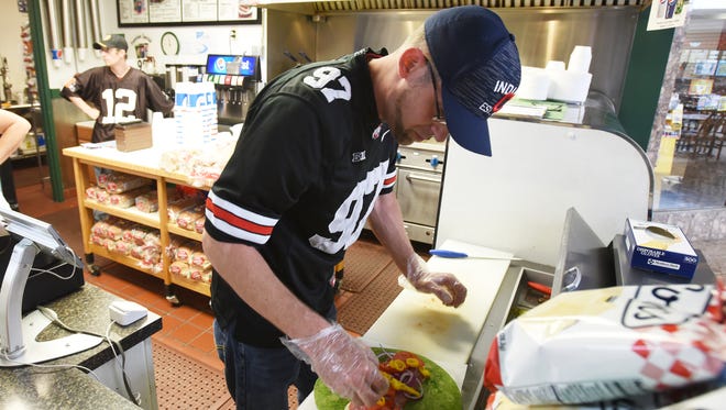 John Martin prepares an Italian wrap at Edie's Deli in the Colony Square Mall. The popular item can be made on a spinach wrap, as pictured, a flour wrap or a tomato wrap.