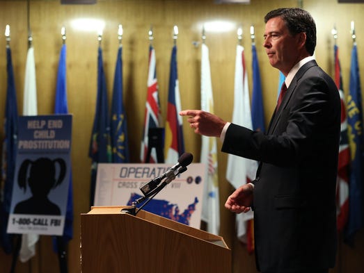 Comey speaks during a news conference on child sex