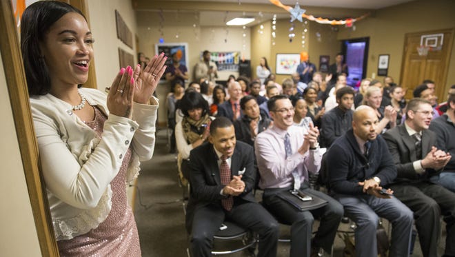 LeAmber Saffold claps during a staff meeting of American Income Life - Indiana in Fishers on March 10, 2016. The office has regular morale-building events at their weekly staff meetings where they often recognize top performers.