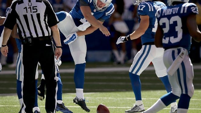 Indianapolis Colt Pat McAfee celebrates his onside kick to in the first quarter. The Indianapolis Colts played the Tennessee Titans Sunday. September 28, 2014, afternoon at Lucas Oil Stadium.