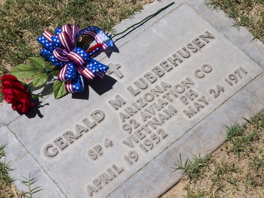 A flower is left at the grave of Spc. Gerald Lubbehusen