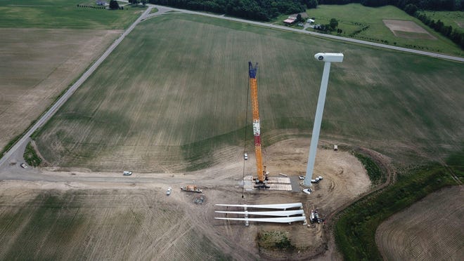 Three blades are ready to hoisted to a turbine at the Scioto Ridge Wind Farm. Seventy-five wind turbines are being built there in all.
