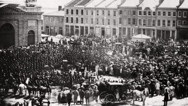 People crowd into Kingston's Market Square in Ontario on July 1, 1867, as the confederation of Canada is proclaimed.