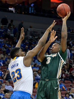 UAB's Chris Cokley. right, shoots over the defense of UCLA's Tony Parker during the second half of an NCAA tournament third round college basketball game in Louisville, Ky., Saturday, March 21, 2015. (AP Photo/Timothy D. Easley)