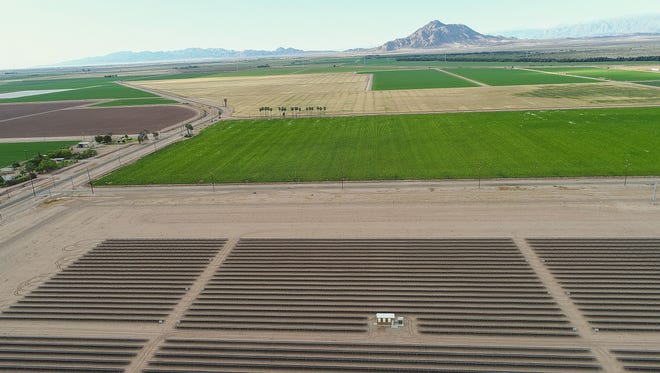 The Campo Verde solar project, seen from a drone, is adjacent to farmland owned by Mike Abatti. Mount Signal, in Mexico, looms in the background.