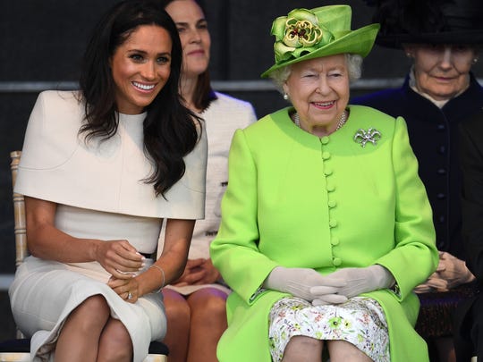 Queen Elizabeth II sits with Meghan, Duchess of Sussex