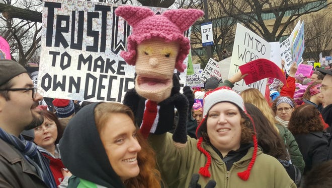 A participant displays a Donald Trump puppet wearing a "pussyhat" -- the hat is a reference to lewd remarks made by Trump -- during the Women's March on Washington on Saturday.