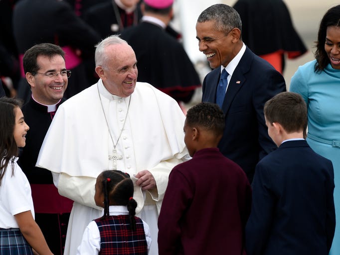 Pope Francis is greeted by four children as he arrives.