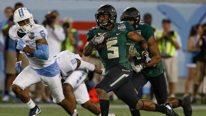 Baylor Bears running back Johnny Jefferson (5) runs the ball 80 yards for a touchdown as North Carolina Tar Heels cornerback M.J. Stewart (6) gives chase during the second half of a football game at Florida Citrus Bowl. Baylor won 49-38.  Mandatory Credit: Reinhold Matay-USA TODAY Sports